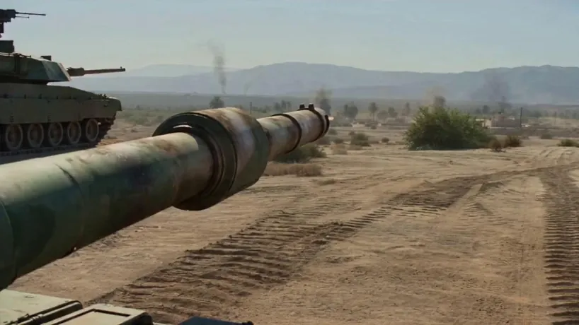 Cinematic VFX war sequence shot on Arri Alexa 65 with a high-speed tracking shot featuring an extreme close-up of a main battle tank's barrel as it recoils violently, triggering a hyper-realistic bullet-time transition. As the shell exits the muzzle, time slows to a near-halt, revealing a massive, intricate shockwave of fire and sand frozen in mid-air. The camera follows the spinning, glowing projectile as it ripples through heat-distorted air toward a target armored vehicle. Upon impact, the armor buckles in slow motion, sending sparks and molten metal fragments spraying outward in exquisite detail. Just as the internal explosion begins to expand, time snaps back to full speed with a deafening blast and a massive plume of black smoke. The atmosphere is gritty and overwhelming, shifting from a silent, frozen mechanical moment to a chaotic, high-intensity battlefield climax.climax.