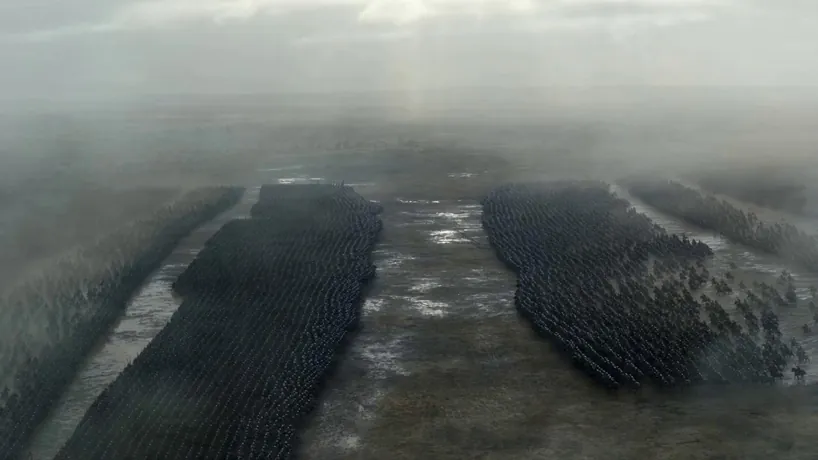 Epic medieval war, shot on Arri Alexa LF with anamorphic lenses, desaturated gritty palette, aggressive rhythmic editing, and immersive chaotic atmosphere.
S1: Extreme wide high-angle drone shot of two massive iron-clad armies colliding on a muddy, fog-shrouded plain under a stormy sky.
S2: Low-angle handheld tracking shot following a wave of heavy cavalry charging at full gallop, mud spraying the lens as they impact the front line.
S3: Close-up of a grim European commander with a blood-streaked face shouting a guttural war cry amidst the deafening roar of battle.
S4: Medium slow-motion shot of infantry clashing with shields, steel sparks flying and debris swirling as blades strike heavy plate armor.
S5: Wide panoramic shot of thousands of flaming arrows arching through the dark sky, momentarily illuminating the carnage in amber light.
S6: Ground-level tracking shot moving past a tattered banner falling into the mud, ending on a dramatic silhouette of the victor against a wall of fire.